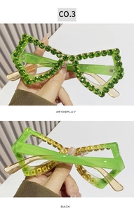 Detail view of fluorescent green butterfly frame sunglasses with emerald rhinestones