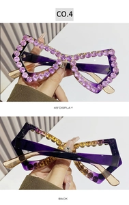 Detail of purple oversized rhinestone sunglasses featuring hand-set crystals and gradient arms