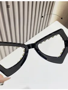 Close-up of oversized geometric eyeglass frame with shimmering rhinestones and nose pads