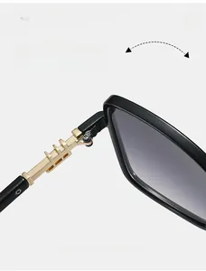 Detail view of durable golden metal hinges and black frame on fashion sunglasses