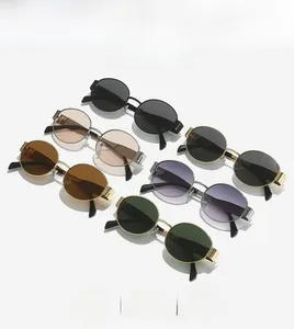 Detail view of oval metal sunglasses collection in multiple colors on white background
