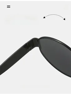 Macro detail of a durable metal hinge on black oval sunglasses for smooth folding