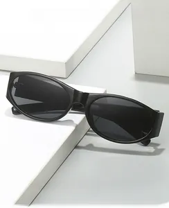 Detail of minimalist oval sunglasses with thick black frames on white geometric stand