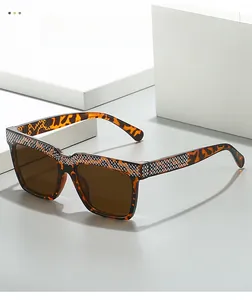 Close-up of leopard print square sunglasses with sparkling rhinestone embellishments