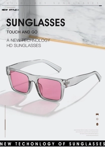 Detail of trendy square sunglasses with pink lenses and transparent grey frame