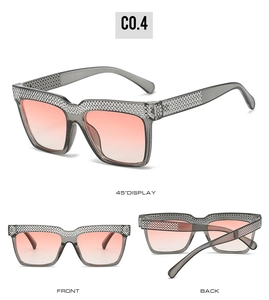 Detail of square oversized sunglasses with pink gradient lenses and silver rhinestones