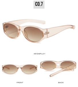 Detail view of oval sunglasses with transparent champagne frames and gradient brown lenses