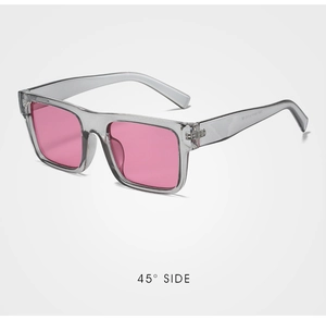 Detail view of square sunglasses with translucent grey frame and pink lenses at 45 degree angle
