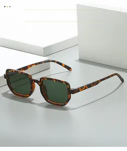 Close-up of tortoise shell square sunglasses with dark green lenses and retro frame detail