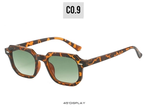 Detail view of 45-degree angle tortoiseshell square sunglasses with green lenses