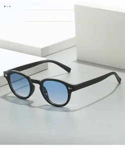 Detail of retro sunglasses with black frame, blue gradient lens and silver rivets