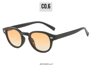 Detail view of vintage round sunglasses with black frames and orange gradient lenses at 45 degrees