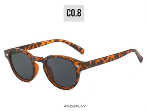 Detail view of tortoiseshell sunglasses featuring silver diamond rivets and 45-degree angle