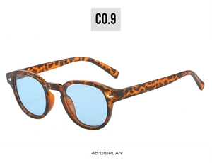 Detail of retro round leopard sunglasses with blue lenses and silver rivets at 45-degree angle
