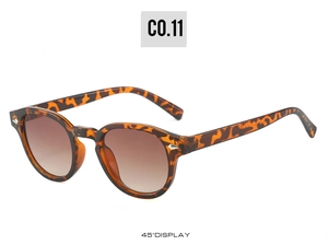 Detail view of tortoiseshell round sunglasses with brown lenses and CE mark on temple