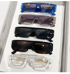Detail of five pairs of rectangular sunglasses featuring metallic panther emblems on the frames