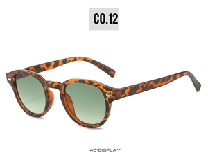Detailed 45-degree side view of vintage round leopard print frames with green lenses
