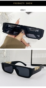Detail of black rectangular sunglasses with gold panther accent and dark grey lenses