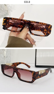 Detail of golden leopard emblem on tortoise shell pattern vintage rectangular sunglasses