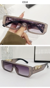 Detailed view of rectangle sunglasses with purple gradient lenses and gold panther accents