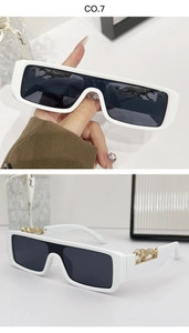 Close-up of retro white square sunglasses featuring golden leopard metal temple accents