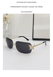 Detail of rimless sunglasses featuring a gold butterfly accent with small crystals