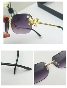 Detail of gradient purple rimless sunglasses featuring golden butterfly hinge with rhinestones