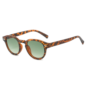 Retro round tortoiseshell sunglasses with dark green lenses and silver rivet accents
