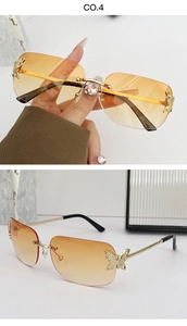 Detail of rimless sunglasses with orange gradient lenses and metal butterfly accents