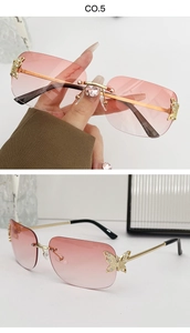 Detail of rimless sunglasses featuring pink gradient lenses and gold butterfly crystal hinge