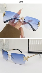 Detail of gradient blue rimless sunglasses with gold butterfly rhinestone accents
