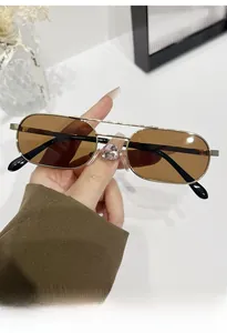 Detail of vintage square metal sunglasses with double bridge and brown lenses