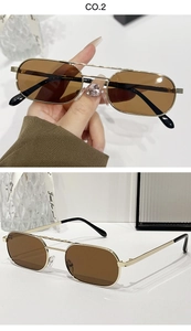 Detail view of gold metal double bridge sunglasses with brown lenses and sleek narrow frame