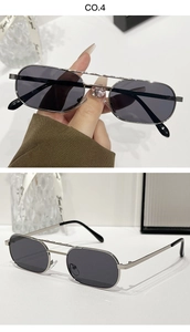 Close-up of silver metal double-bridge sunglasses with oval lenses and textured frame