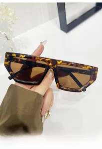 Detail view of tortoiseshell diamond-frame sunglasses with brown lenses and side temple specs