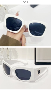 Détail de lunettes de soleil carrées blanches avec anneau en métal sur la branche