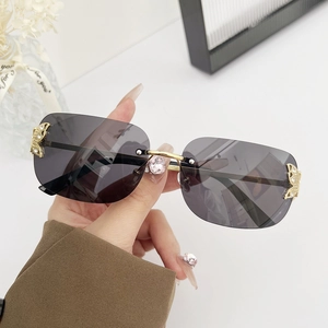 Fashionable rimless sunglasses with dark grey square lenses and gold butterfly accents