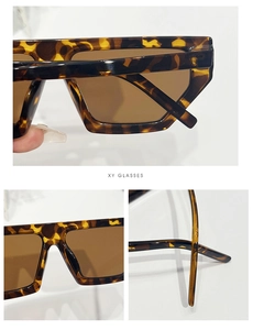Detailed close-up of leopard print frames and brown rectangular lenses for retro sunglasses