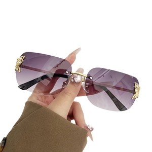 Fashionable rimless butterfly sunglasses with purple gradient lenses and gold rhinestones