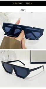 Detail view of black geometric pentagon sunglasses frame with dark grey UV lenses