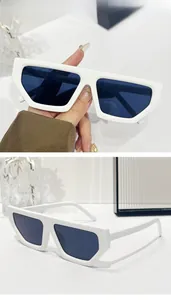 Detailed close-up of white geometric sunglasses with flat top and dark lenses