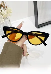 Close-up of cat-eye sunglasses featuring black frames and yellow transparent lenses