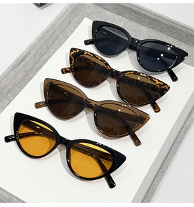Detailed display of four retro cat eye sunglasses in various frame colors on a white card