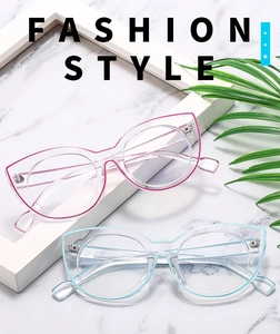 Detail of rose pink and azure blue transparent cat eye glasses frames on marble surface
