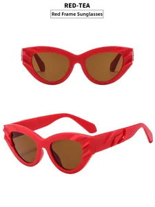 Detail of red cat-eye sunglasses with tea lenses and textured wave pattern on frames
