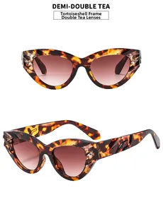 Close-up of retro cat eye sunglasses in tortoiseshell frame with gradient brown lenses
