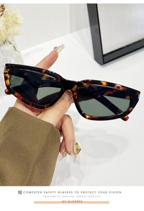 Detail of tortoise shell square sunglasses showing frame thickness and lens quality