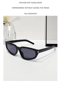 Detail of black cat-eye sunglasses featuring silver metal accents on a clean white surface