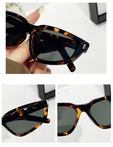 Detail view of tortoiseshell frame sunglasses with dark green lenses and silver hinges