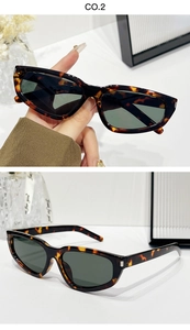 Detail of dark tortoiseshell rectangular sunglasses with green lenses and silver accents